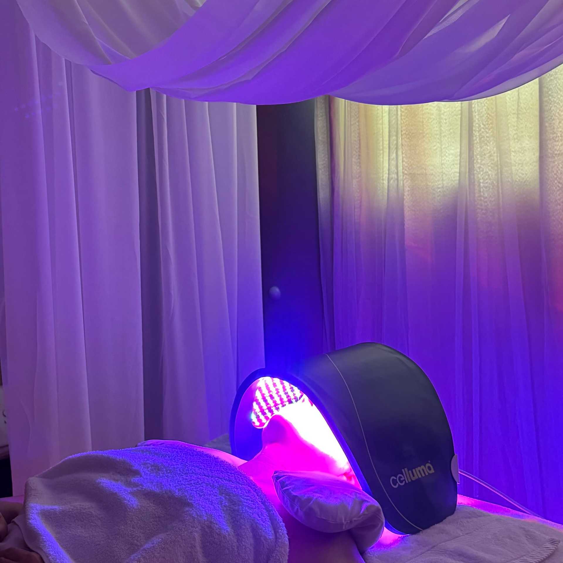 LED light therapy device used on a person in a relaxing spa setting.